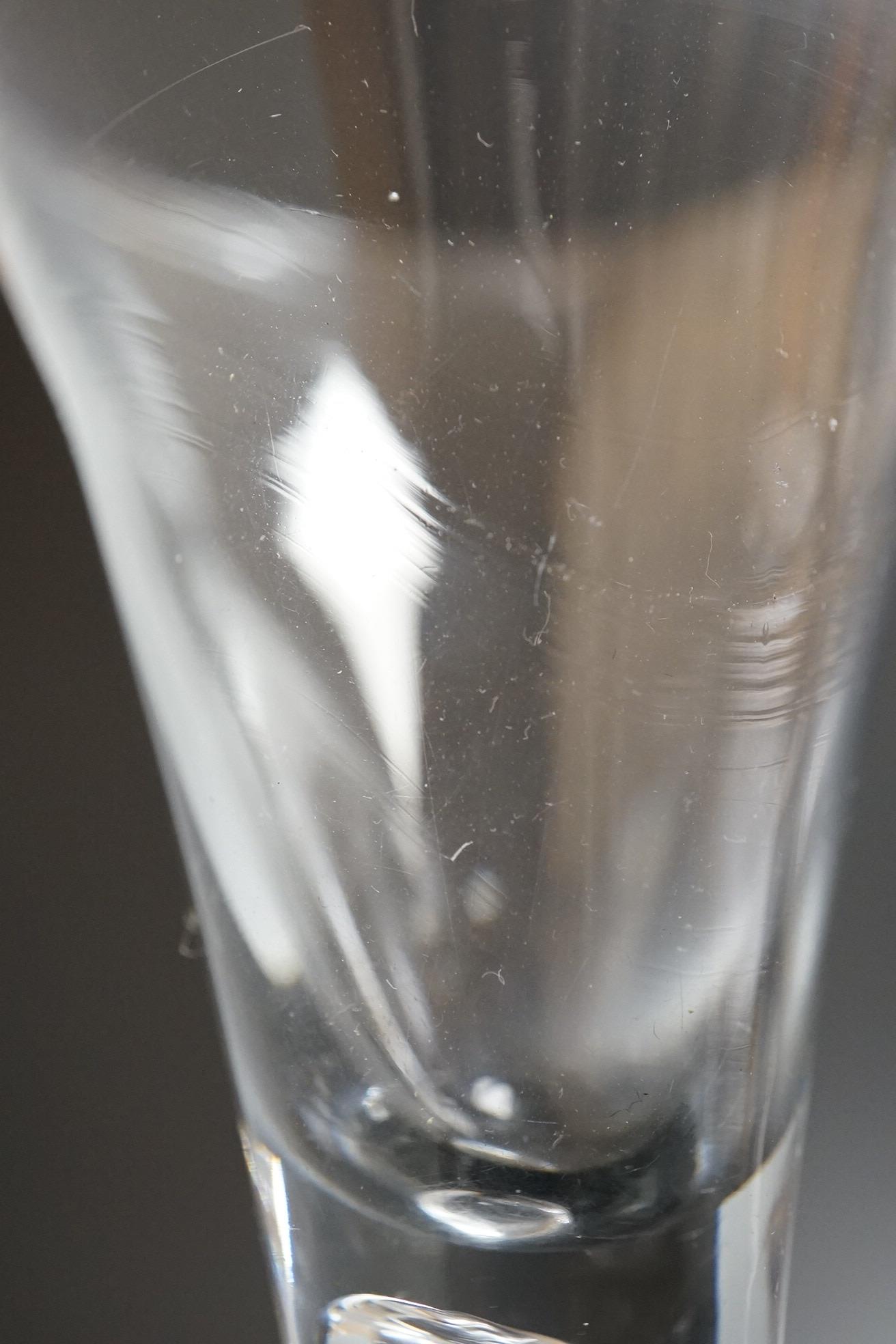Two 18th century glass wine flutes, one with folded foot, tallest 16cm high